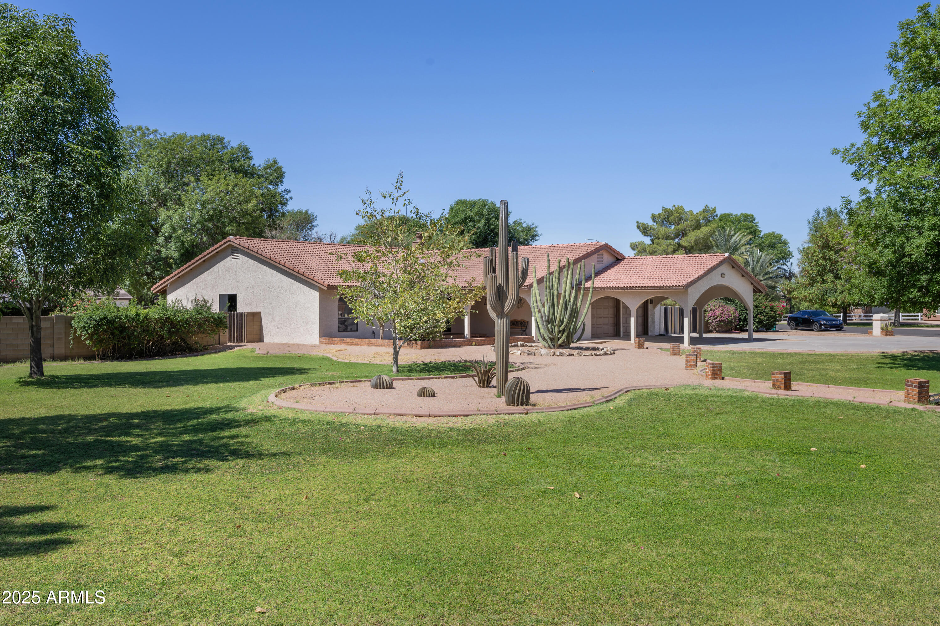 a front view of house with a garden and trees