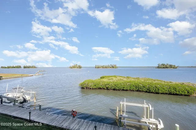 a view of a lake with a table and chairs