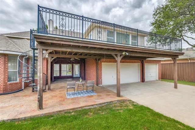 a view of a house with a small yard and wooden fence
