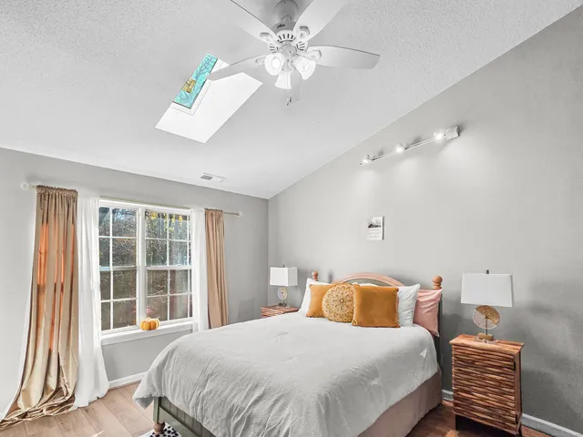 a bedroom with a large bed and a window