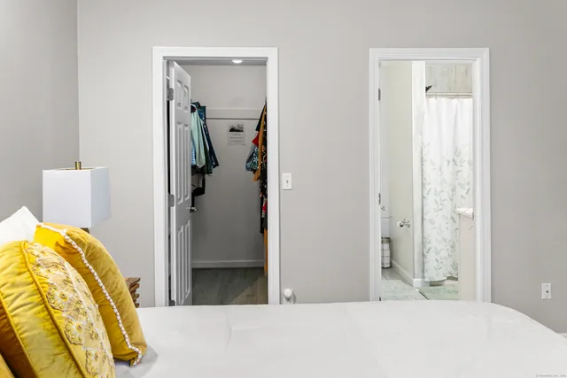 a bedroom with a bed and a mirror