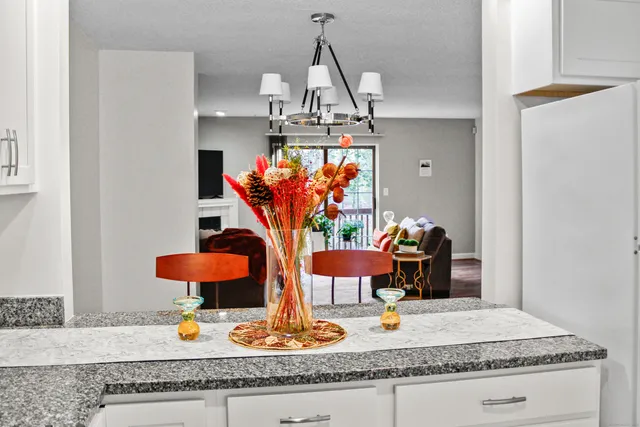 a view of a kitchen with furniture and wooden floor