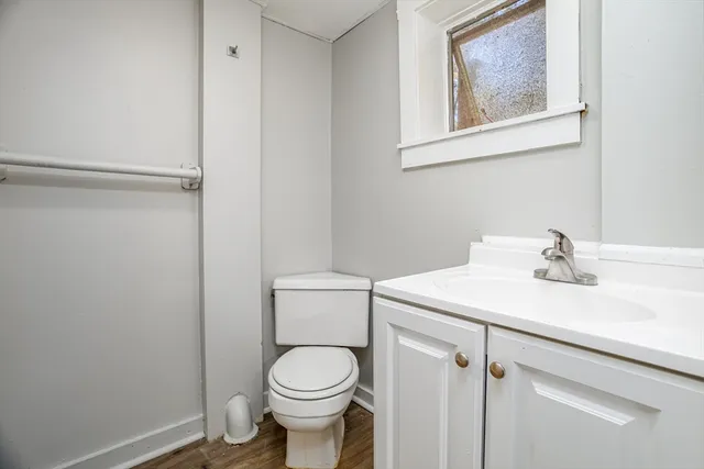 a bathroom with a sink mirror vanity and toilet