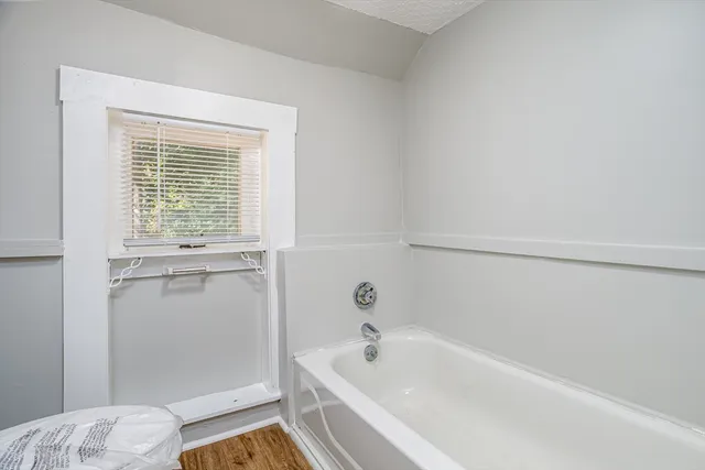 a white bath tub sitting next to a window