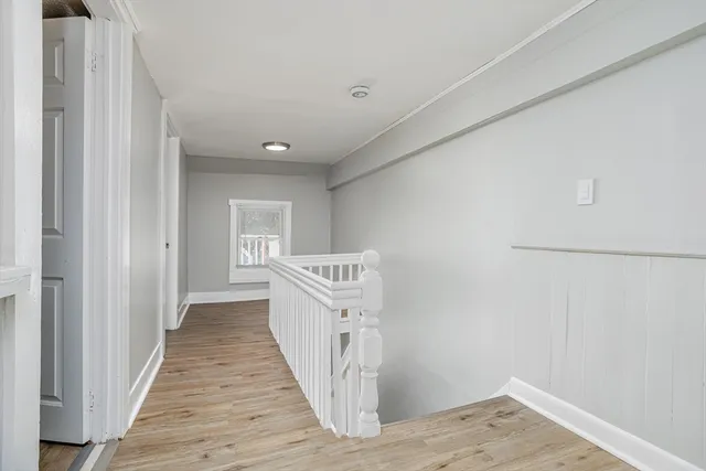 a view of a hallway with wooden floor