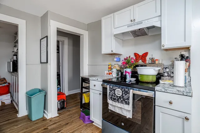 a kitchen with stainless steel appliances granite countertop a refrigerator and stove top oven
