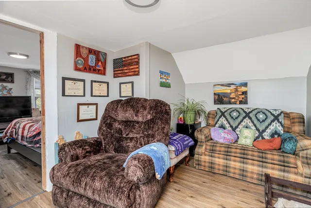 a living room with furniture and painting on the wall