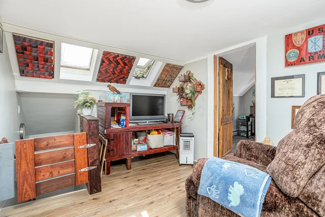 a bedroom with furniture and a flat screen tv