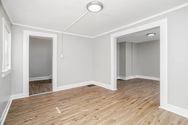 an empty room with wooden floor and closet