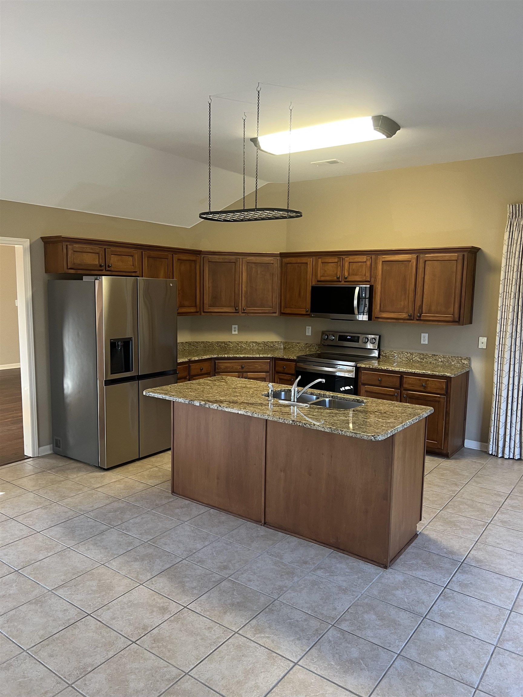 203 Estanaula Road Collierville, TN 38017 - Photo 15 of 31 a kitchen with stainless steel appliances granite countertop a stove a sink and a refrigerator