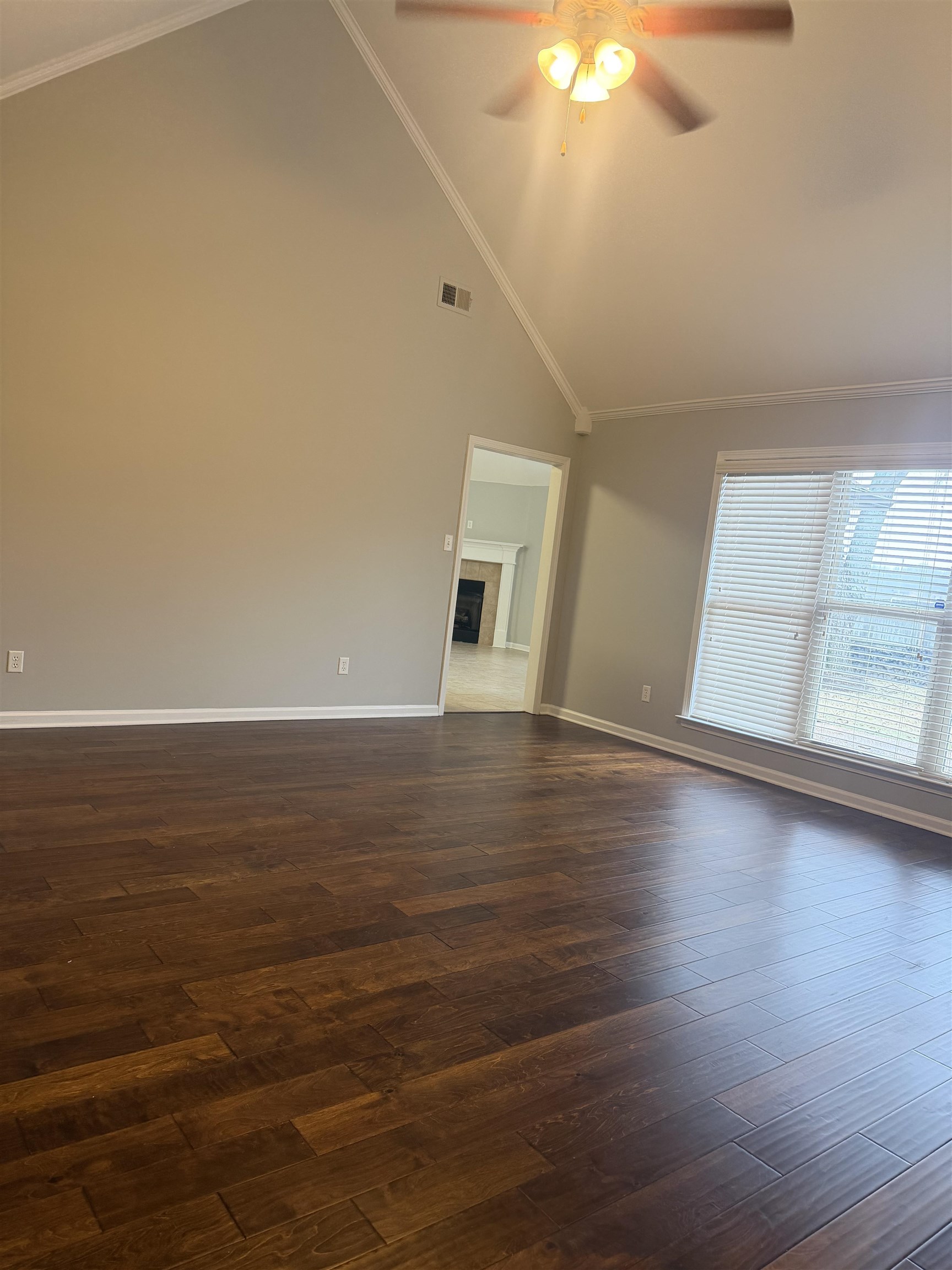 203 Estanaula Road Collierville, TN 38017 - Photo 5 of 31 a view of a livingroom with wooden floor and a ceiling fan