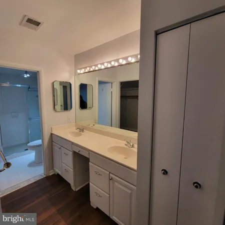 a spacious bathroom with a double vanity sink and a mirror