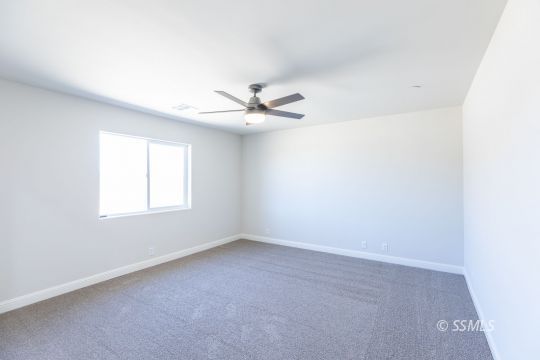 1012 Sims Street Ridgecrest, CA 93555 - Photo 26 of 36 an empty room with a window and a fan