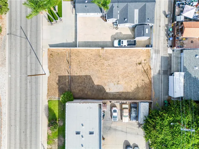 an aerial view of a house with a yard and potted plants