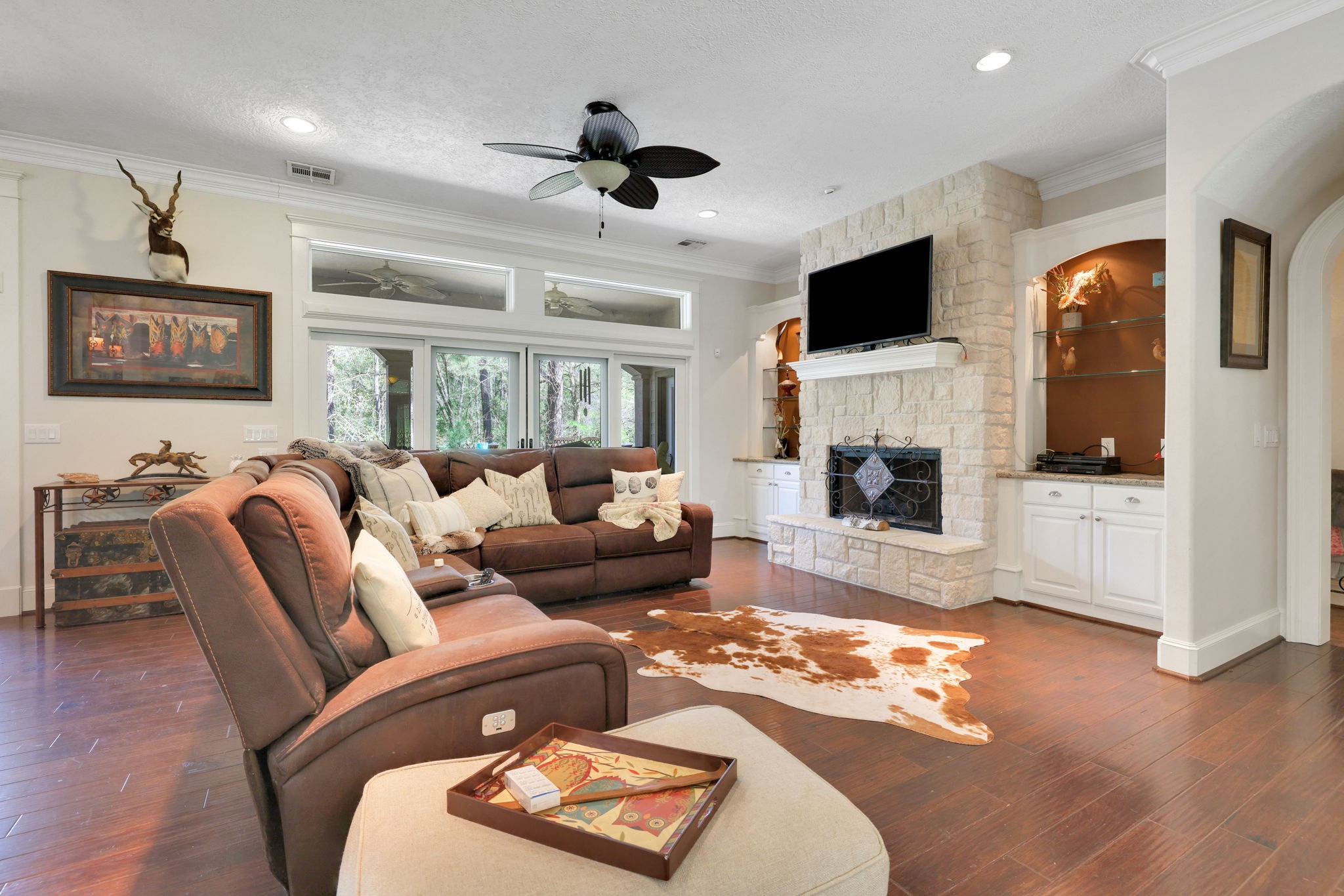 250 Critter Creek Road Coldspring, TX 77331 - Photo 8 of 48 The living area has a wood burning fireplace with white stone wood surround and built ins