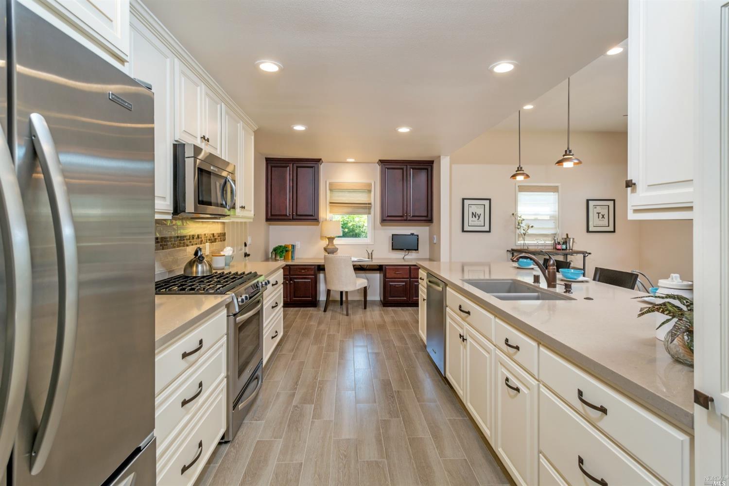 6558 Stonecroft Terrace Santa Rosa, CA 95409 - Photo 1 of 1 Stunning kitchen upgrades including stone counter tops, tile floor, gas stove, stainless refrigerator.