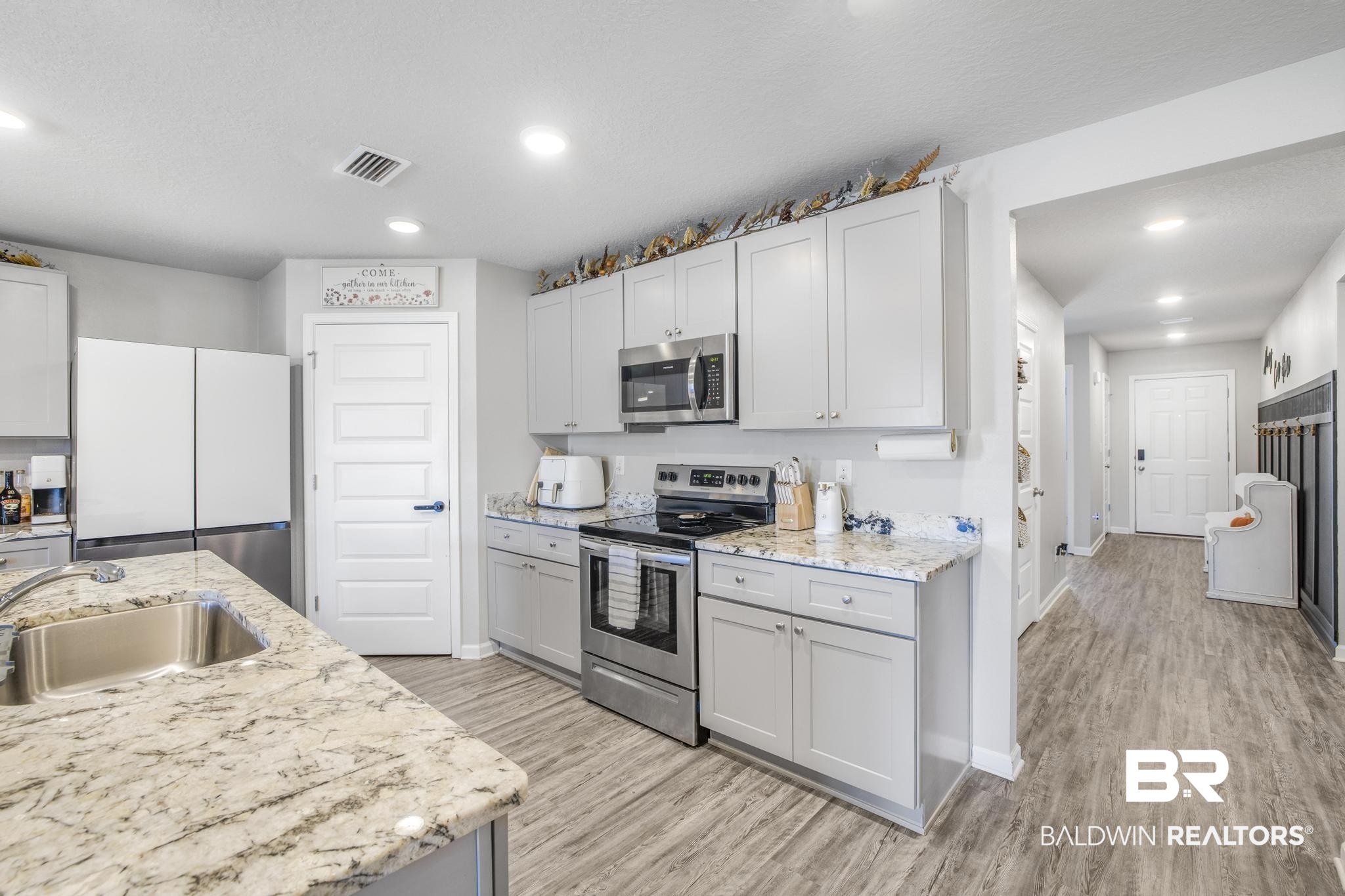 10738 Ridgeview Drive Mobile, AL 36608 - Photo 5 of 48 Kitchen featuring appliances with stainless steel finishes, recessed lighting, light wood-style flooring, light stone countertops, and gray cabinets