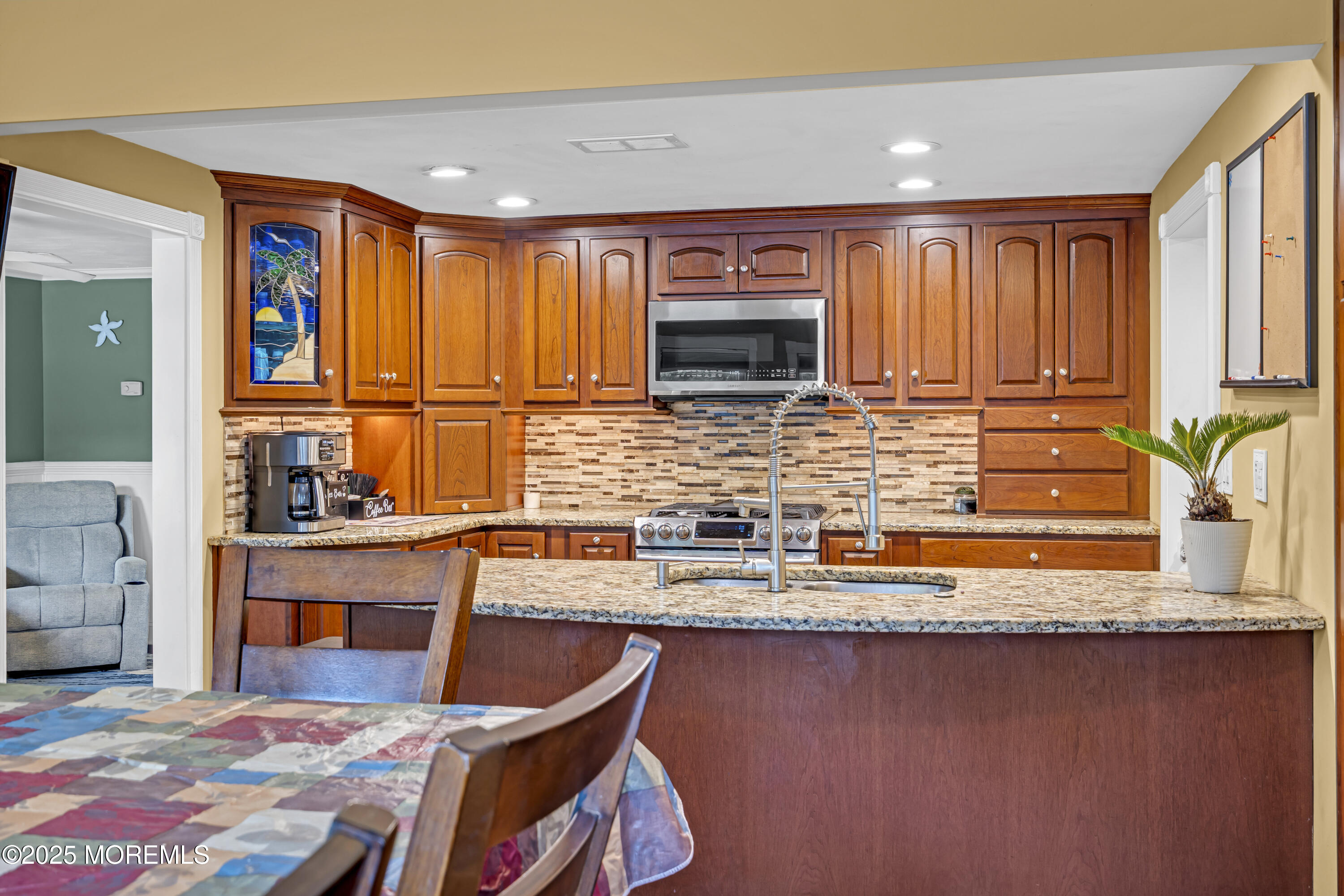 110 4th Avenue Tuckerton, NJ 08087 - Photo 11 of 38 a kitchen with stainless steel appliances granite countertop a stove a sink and a microwave