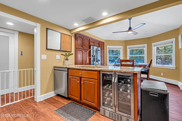 a kitchen with stainless steel appliances granite countertop a stove cabinets and wooden floor