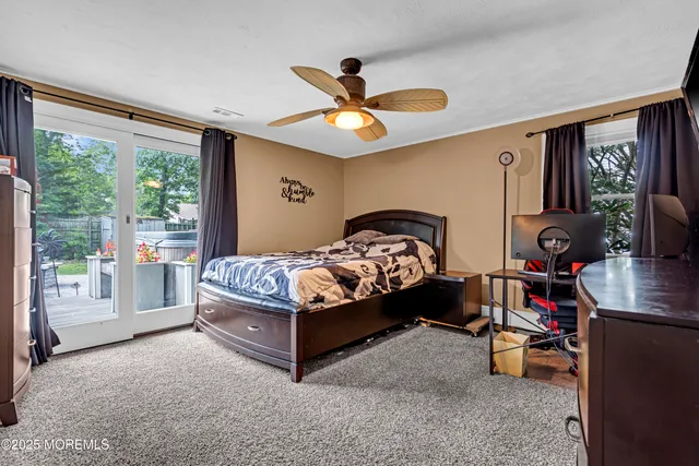 a bedroom with a bed and a large window with the outer view