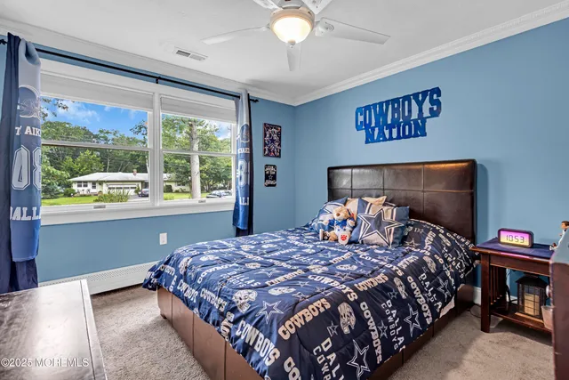 a bed sitting in a bedroom next to a window