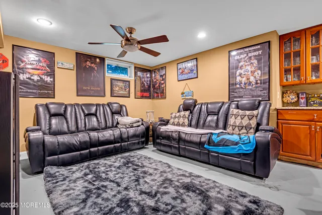 a living room with furniture ceiling fan and a rug