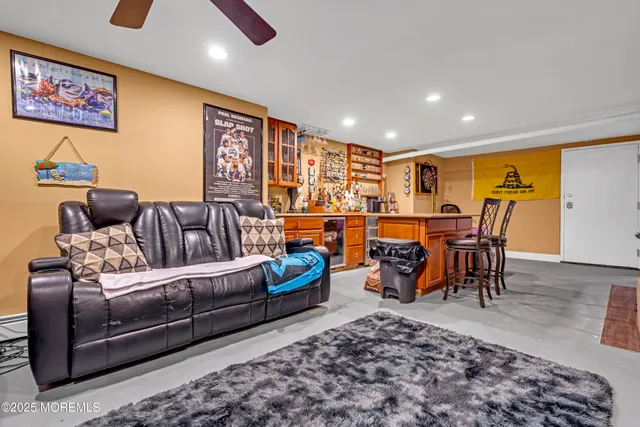 a living room with furniture a wooden floor and next to a window