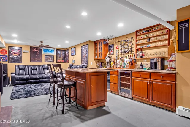 a kitchen with stainless steel appliances granite countertop a refrigerator and wooden cabinets