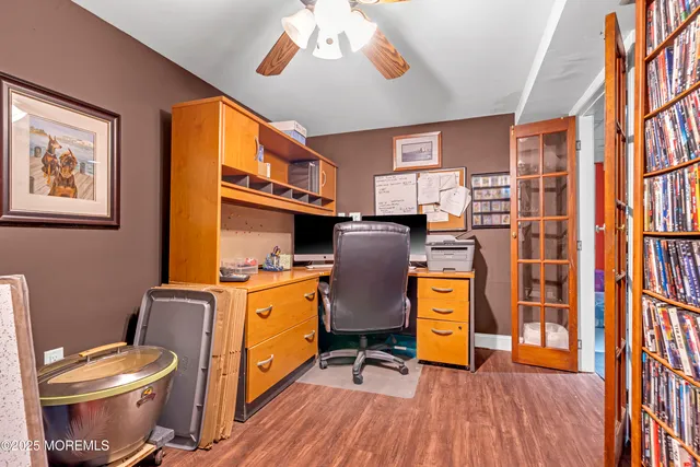 a kitchen with stainless steel appliances a stove a window and wooden floors