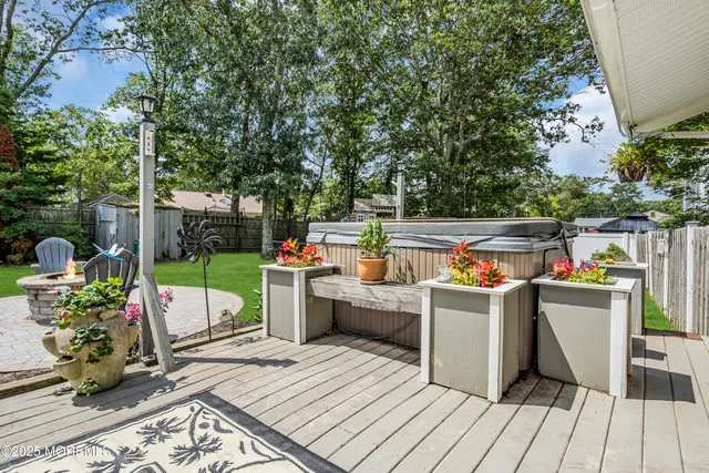 a view of a chairs and table in the back yard of the house