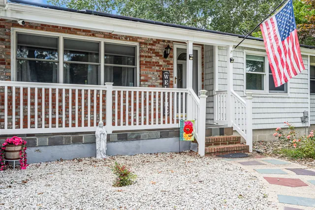a backyard of a house with wooden floor and fence