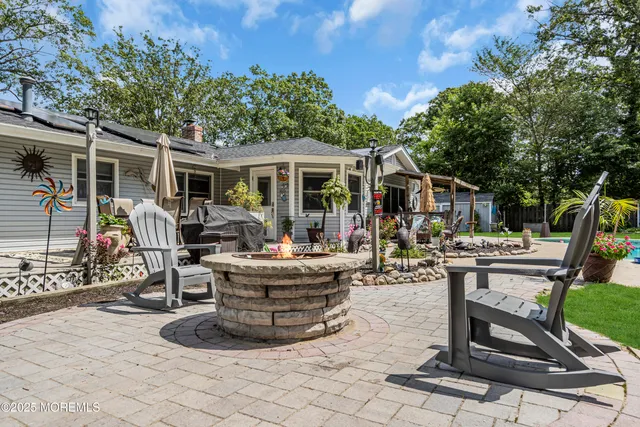 a view of a house with backyard porch and sitting area