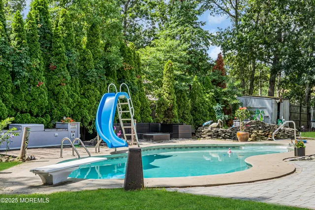 a view of a park with potted plants and large trees