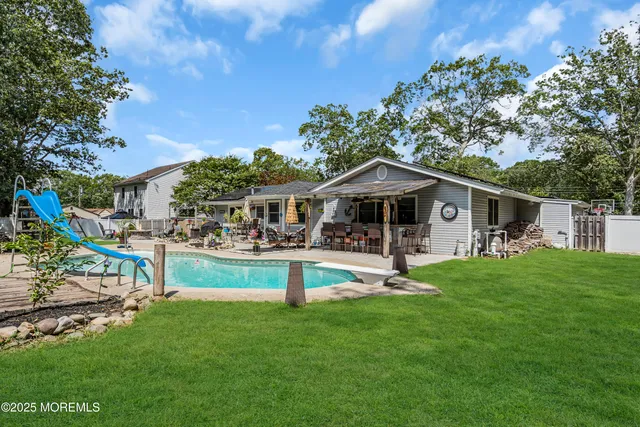 a front view of house with yard and outdoor seating