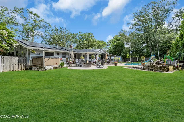 a view of a house with a backyard porch and sitting area