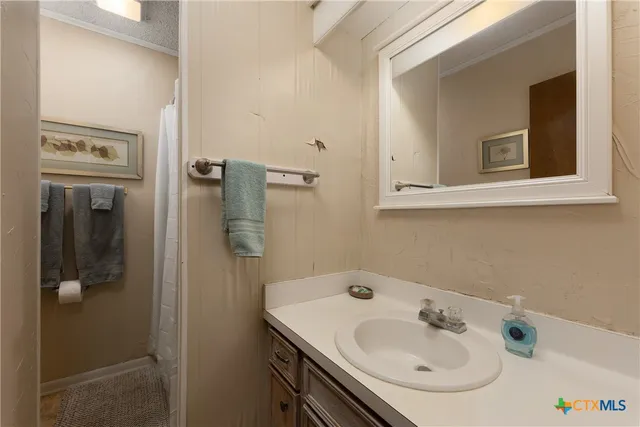 a bathroom with a sink and mirror