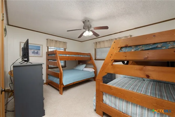 a bedroom with furniture and wooden floor