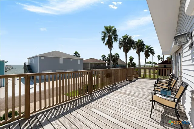 a view of a roof deck with wooden floor and fence
