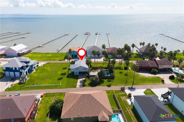 an aerial view of a houses with a lake view