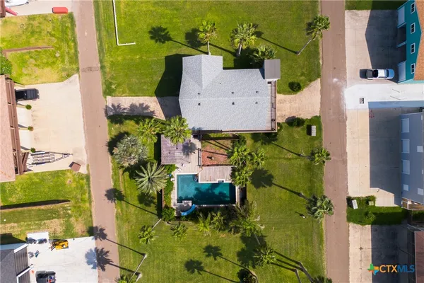 an aerial view of a house with a yard basket ball court and outdoor seating