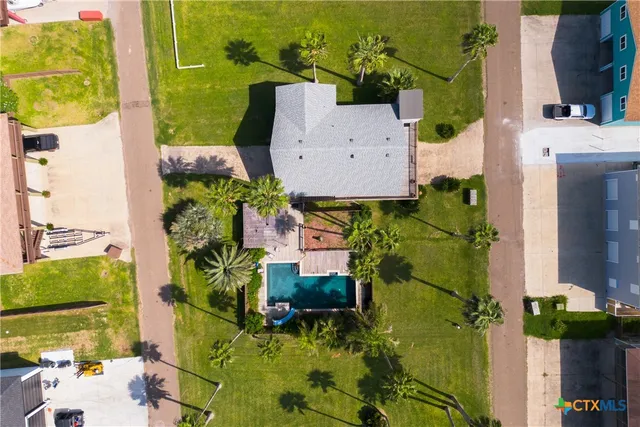 an aerial view of a house with a yard basket ball court and outdoor seating