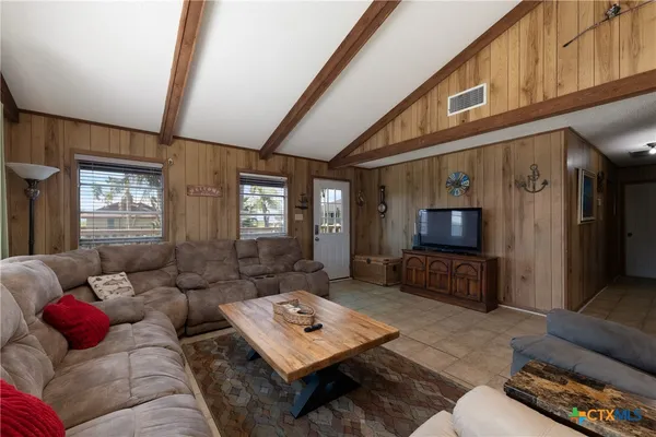 a living room with furniture and a flat screen tv