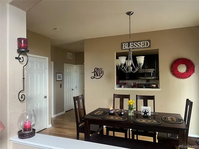 a view of a dining room with furniture and chandelier