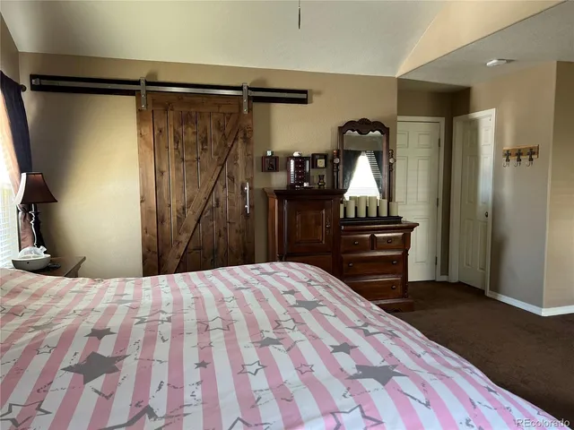 a bedroom with a bed and a bathroom