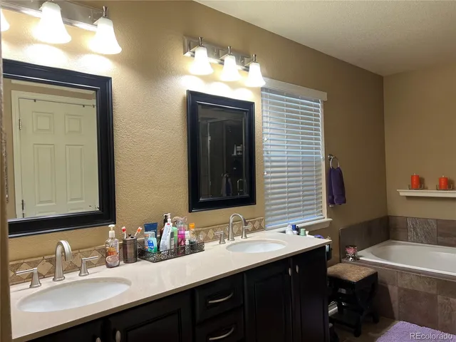 a bathroom with a double vanity sink and a mirror