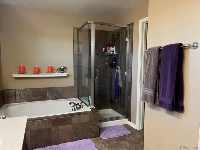 a bathroom with a bathtub and a shower