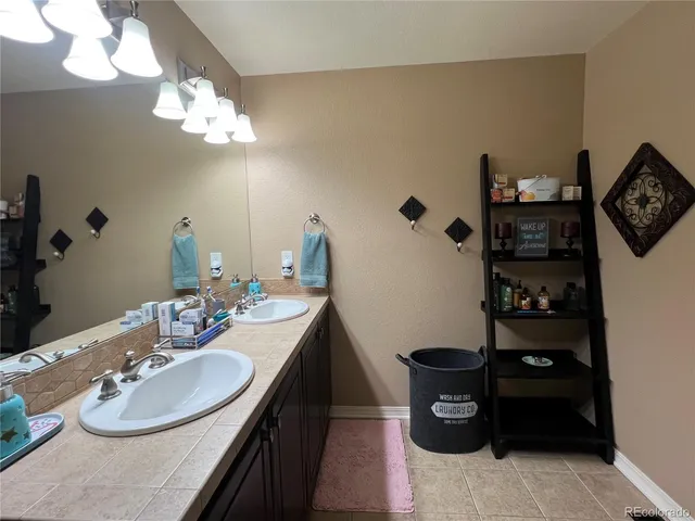a bathroom with a sink vanity and a mirror