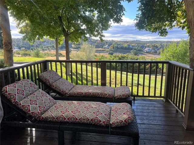 a view of balcony with wooden floor and outdoor seating