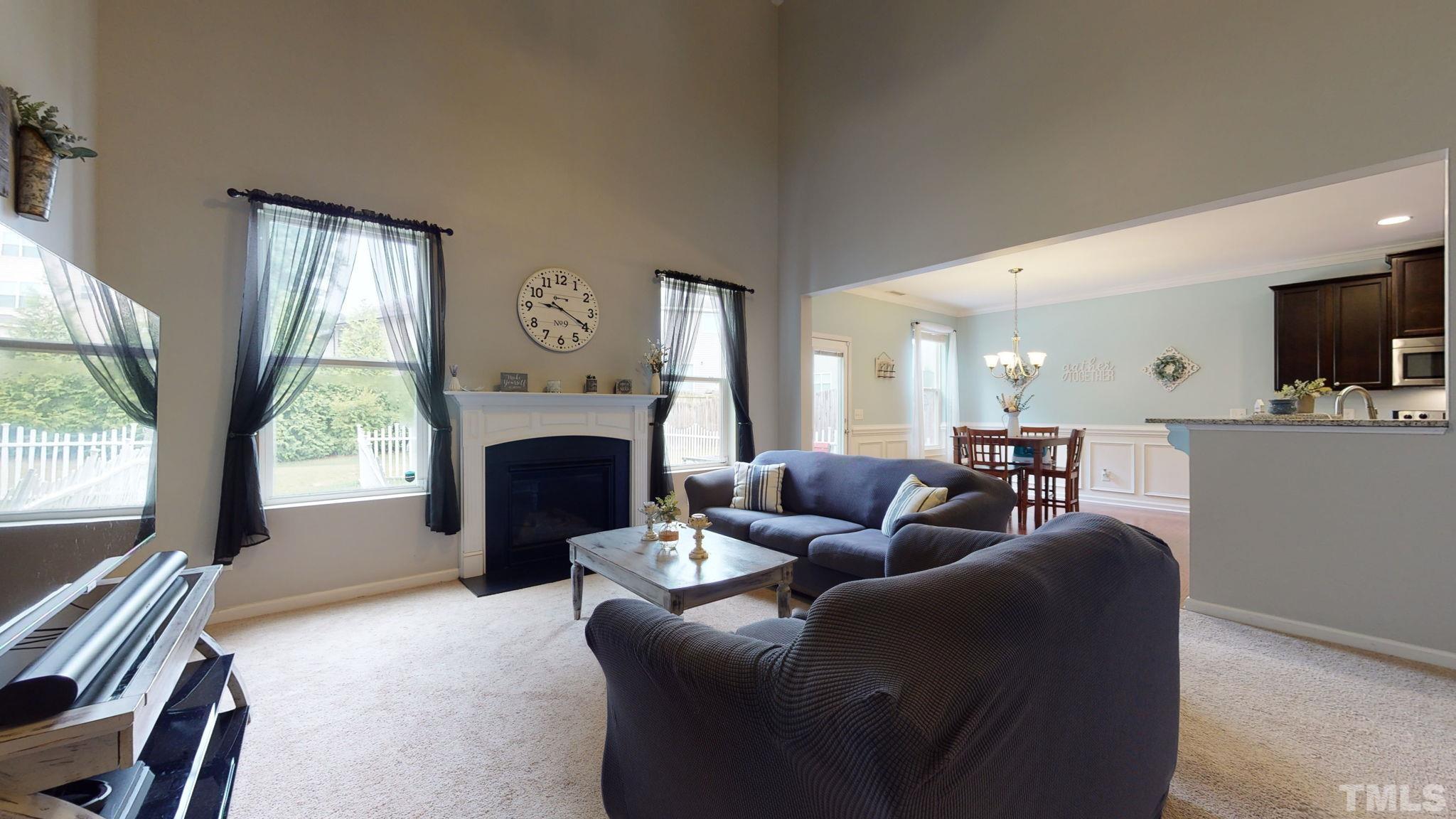 3558 Eastern Branch Road Raleigh, NC 27610 - Photo 13 of 25 a living room with furniture a large window and a fireplace