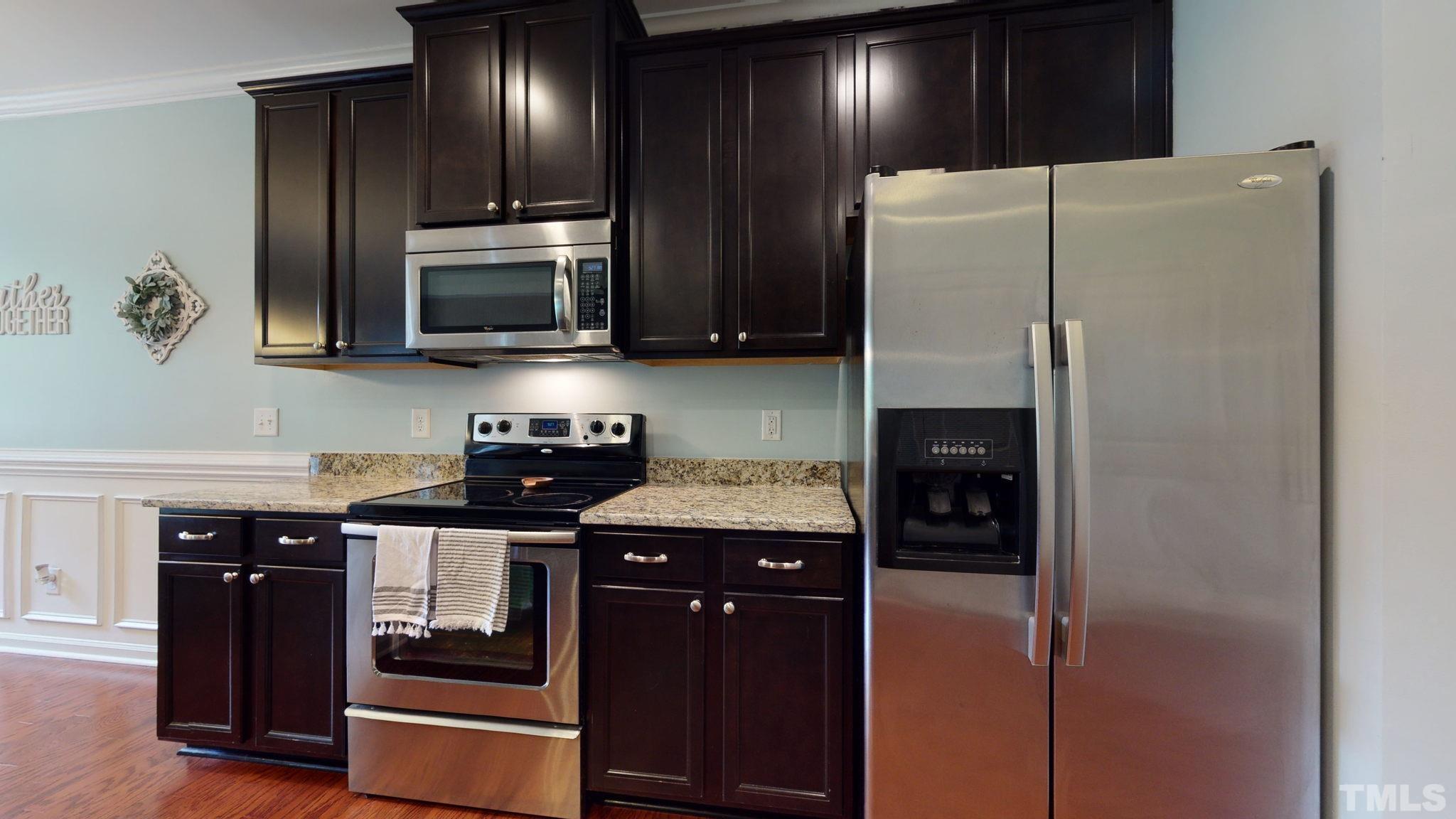 3558 Eastern Branch Road Raleigh, NC 27610 - Photo 16 of 25 a kitchen with stainless steel appliances granite countertop a refrigerator and a stove top oven